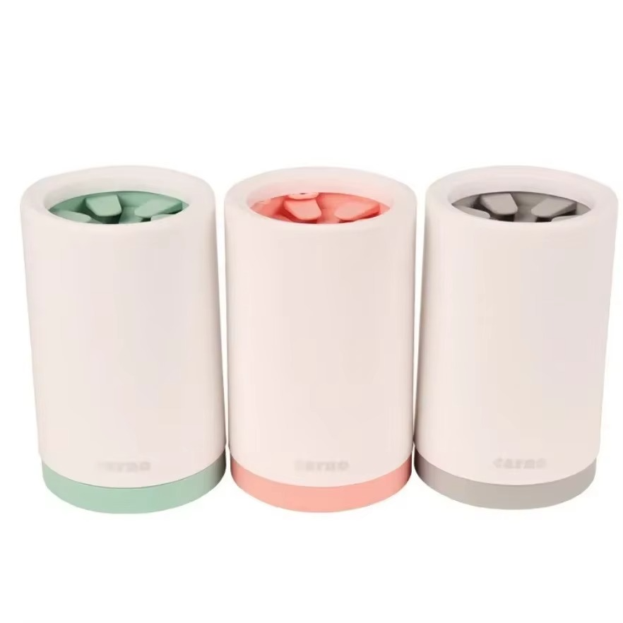 Three cylindrical containers with pastel-colored bases on a white background
